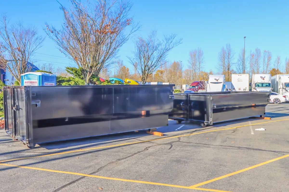 Professional dumpster rental service with roll-off container on residential driveway in Galion